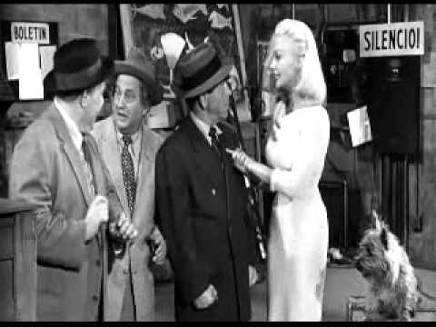 The lovely Greta Thyssen helps the Three Stooges (Joe Besser, Larry Fine, Moe Howard) out with a new job, as her dog looks on