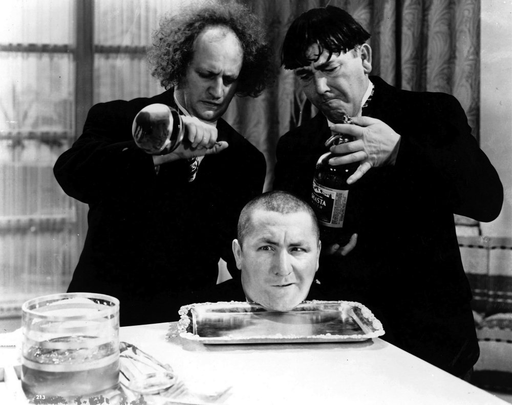 Publicity photograph for the Three Stooges for one of their short films, with Curly's head on a platter.