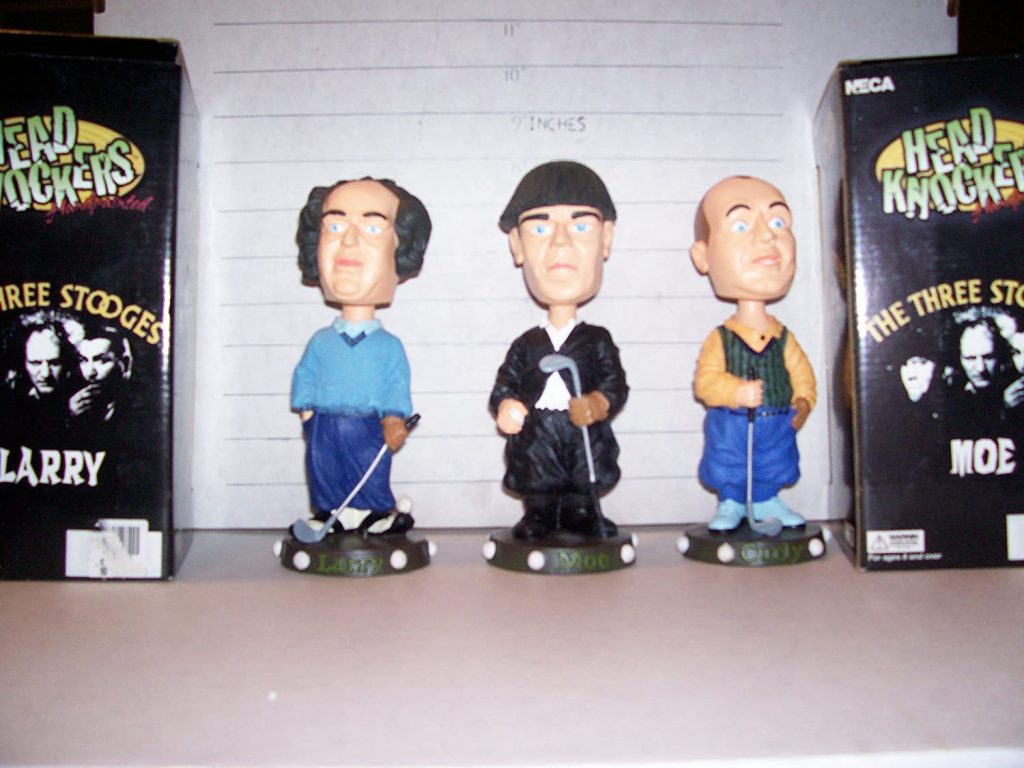 Yes, it's the Three Stooges (Moe Howard, Larry Fine, Curly Howard) as bobbleheads in their golf outfits from Three Little Beers.
