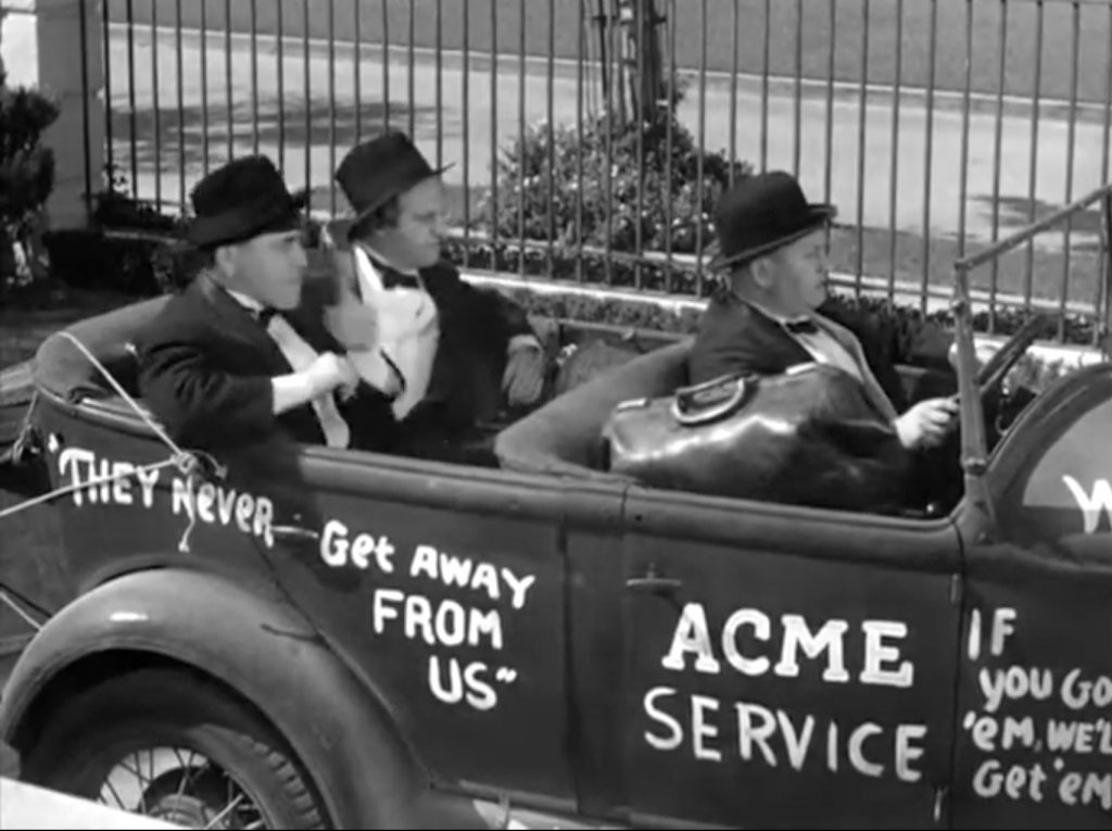 Moe, Larry, and Curly arrive at the fancy party in their pest exterminator car