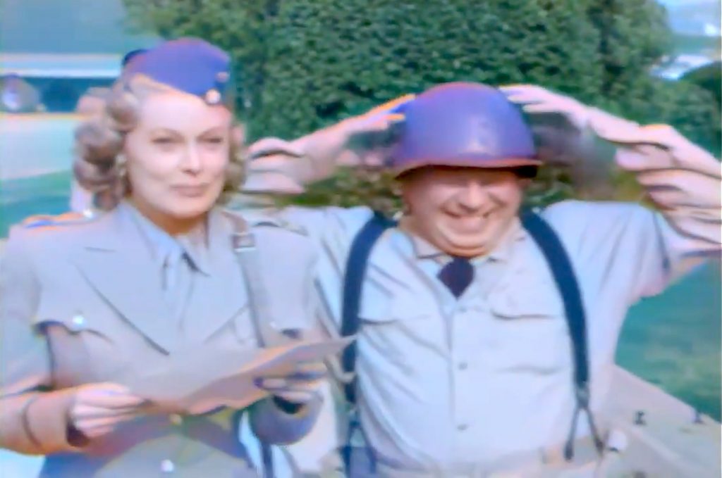 Angela Stevens and Joe Besser walking together in Spies and Guys
