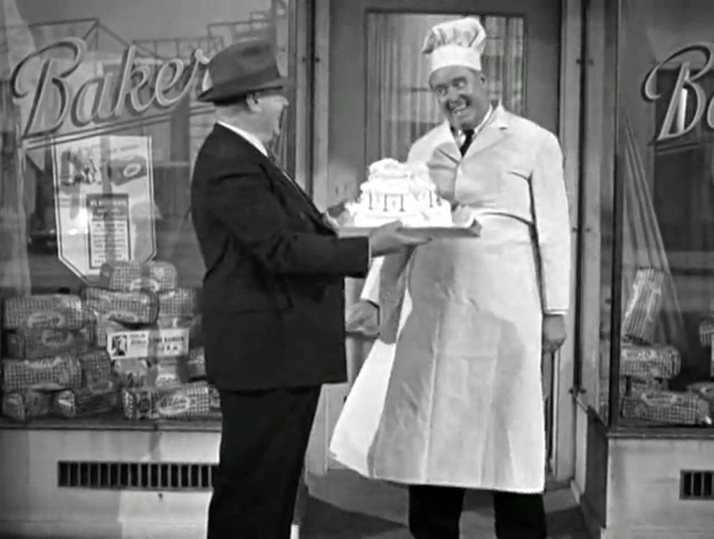 Baker Bud Jamison giving Vernon Dent his birthday cake - be careful!