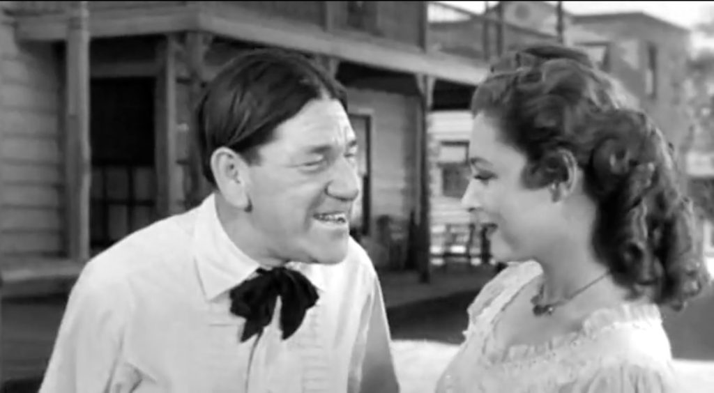 Shemp gets a kiss from his blushing bride at the end of "Shot in the Frontier"
