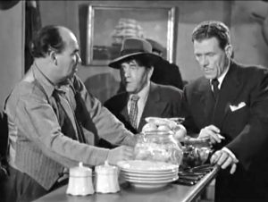 Would-be reporters Moe, Larry and Shemp question the bartender at a seedy waterfront dive, looking for Dapper -- not realizing that he's standing next to them