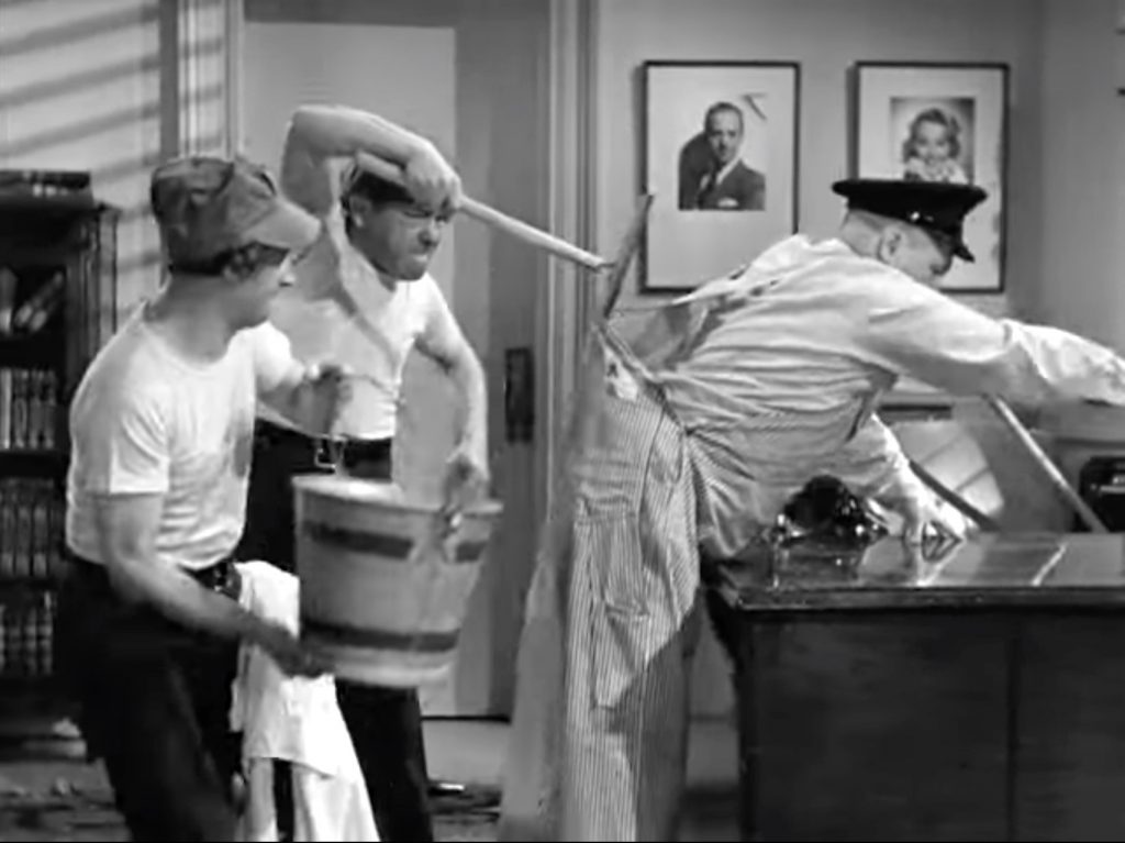 Larry and Moe get revenge on Curly while cleaning the office in "Three Missing Links"