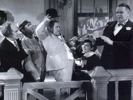 The Three Stooges (with Bud Jamison) in a scene from Disorder in the Court