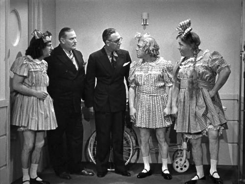 Dr. Vernon Dent with the Three Stooges (Moe, Larry, Curly) having failed to cheer up the little girl …