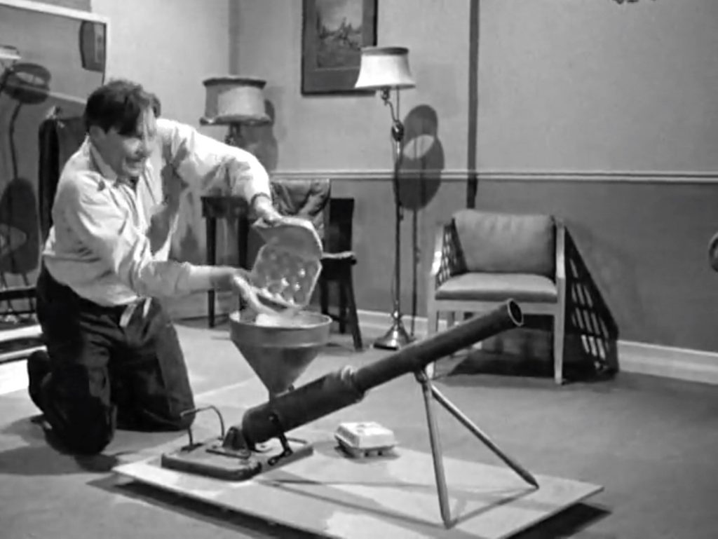 Dick Curtis firing the egg cannon at the Three Stooges in "Don't Throw That Knife!"