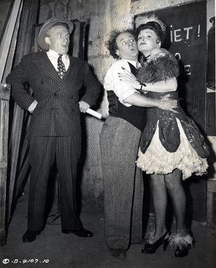 Larry Fine making time with Nanette Bordeaux while Emil Sitka looks on