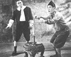 Publicity photo for Fiddlers Three - Moe as Simple Simon, Shemp as Jack Be Nimble