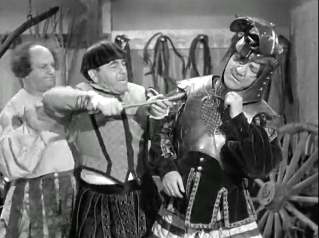 Larry and Moe try to pry Shemp out of the armor