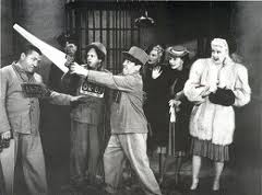 Publicity still for In the Sweet Pie and Pie, showing the Three Stooges (Moe, Larry, Curly) attempting to break out of prison while their wives watch