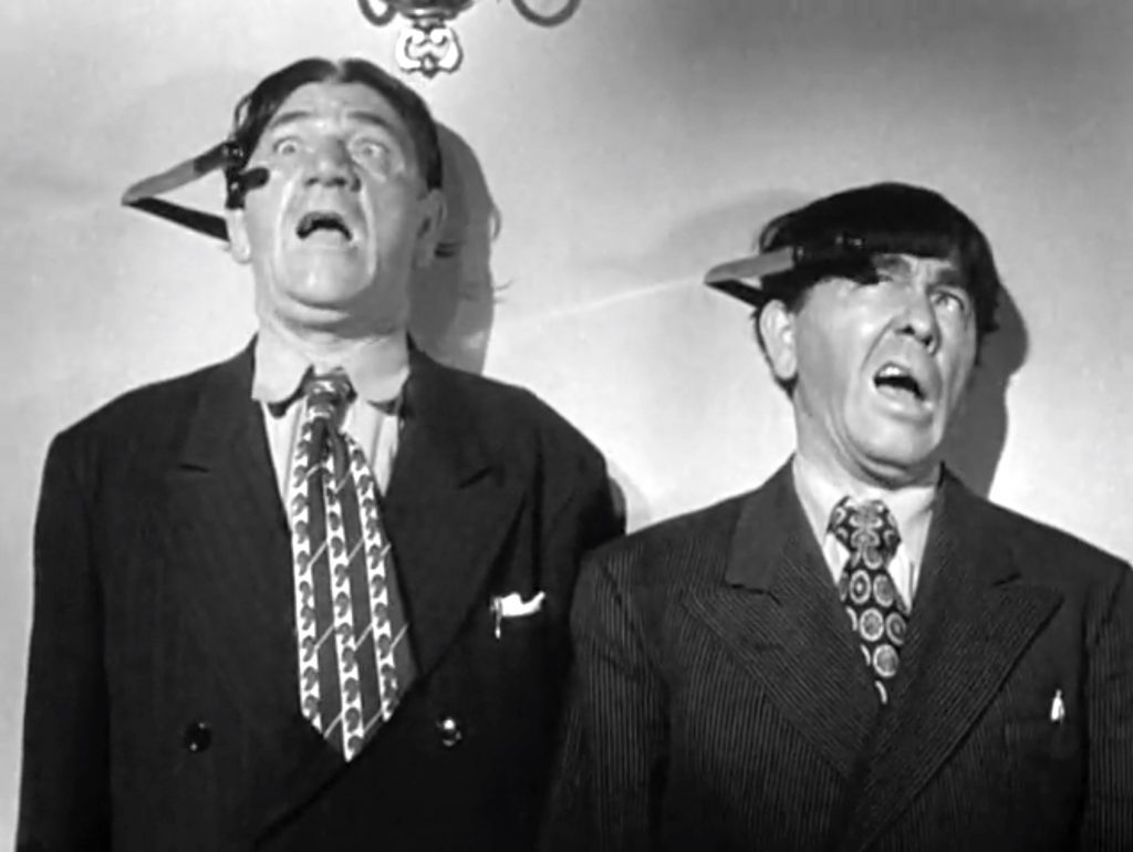 Shemp Howard and Moe at the mercy of the knife thrower in "Don't Throw That Knife!"