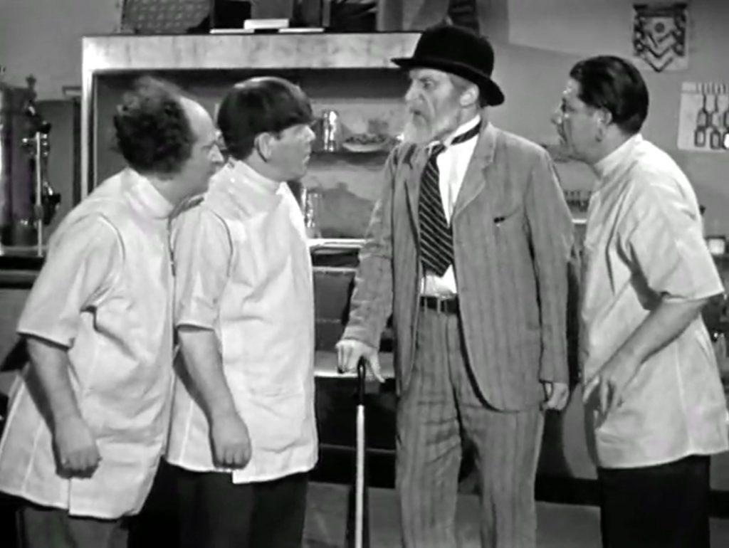 Crotchety Emil Sitka about to show the Three Stooges pharmacists (Larry, Moe, Shemp) out!