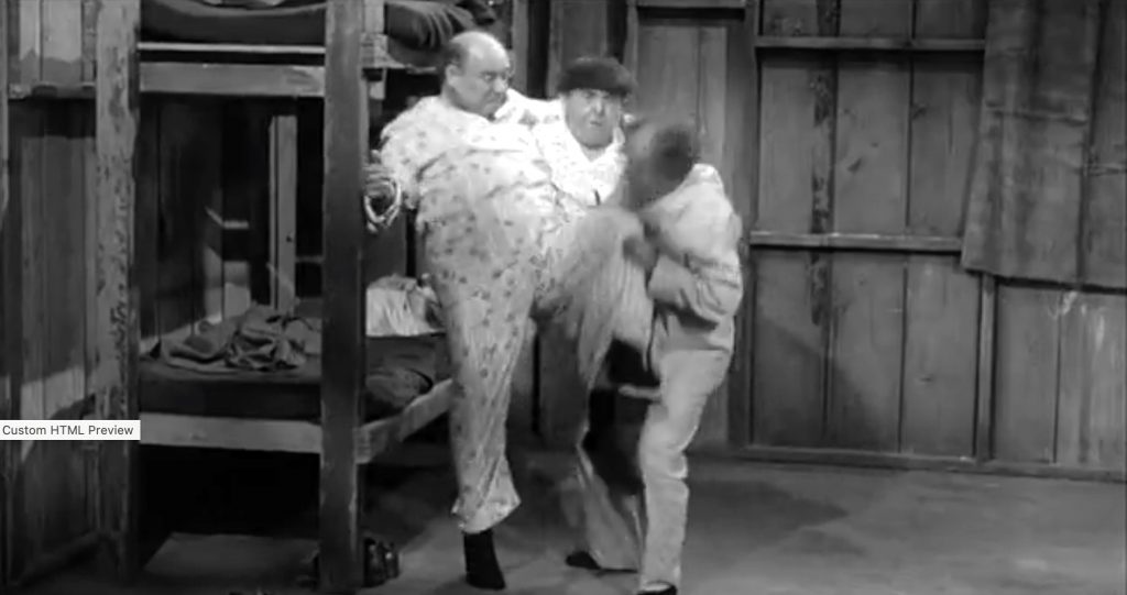 Joe Besser an Moe Howard fighting over Moe's pajama bottoms in "Oil's Well that Ends Well"