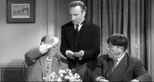 Emil Sitka as Spiffington, serving an imaginary meal to Joe Besser and Moe Howard