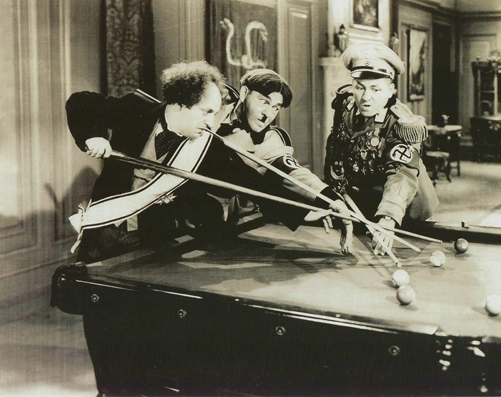 Larry, Moe, and Curly fighting over the pool table - with explosive results - in "I'll Never Heil Again"
