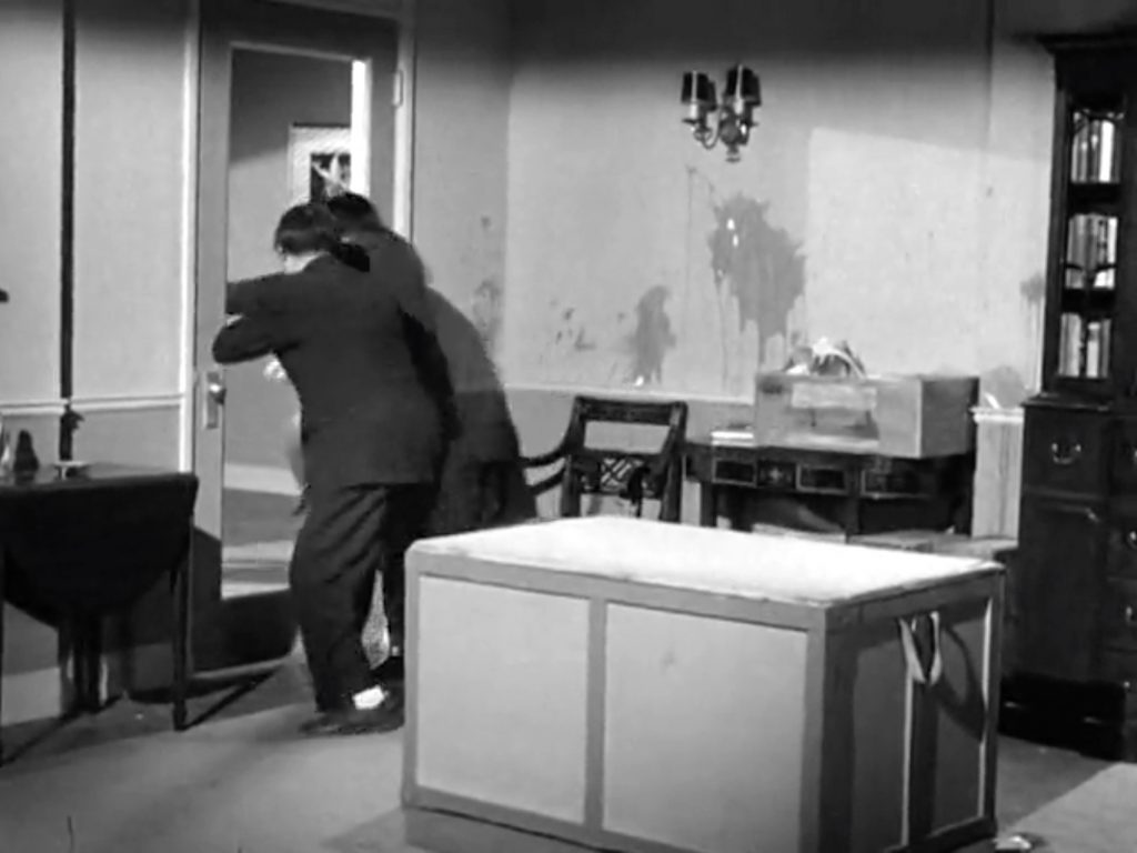 The Three Stooges run *through* the door to get away in "Don't Throw That Knife"