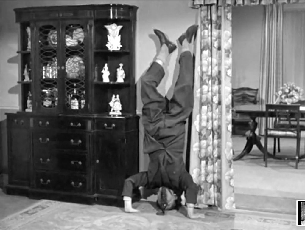 Shemp doing a headstand to stop the baby's crying in "Baby Sitters Jitters"