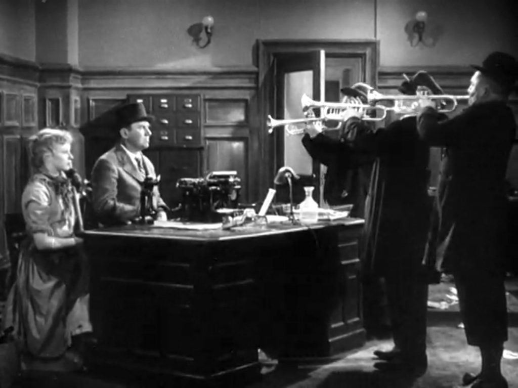 The Three Stooges (Moe, Larry, Curly) burst into Ted Healy's office to play music in "The Big Idea"