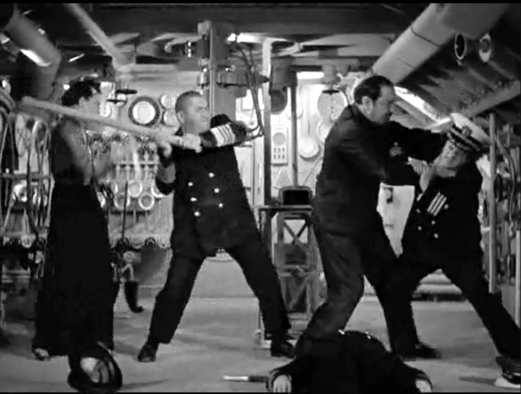 Curly Howard and Larry Fine fight the spies for control of the submarine in "Three Little Sew and Sews"