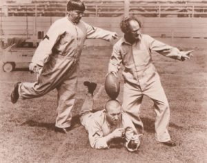 Another still from Three Little Pigskins, colorized this time, showing Curly, Moe and Larry in their uniforms and helmets.