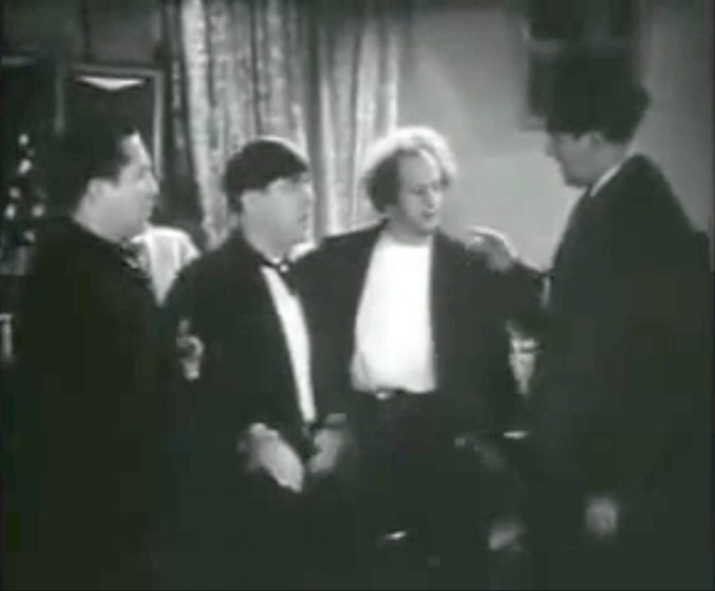 Ted Healy about to do a triple slap to the Three Stooges (Curly, Moe, Larry) in Hollywood on Parade #B9