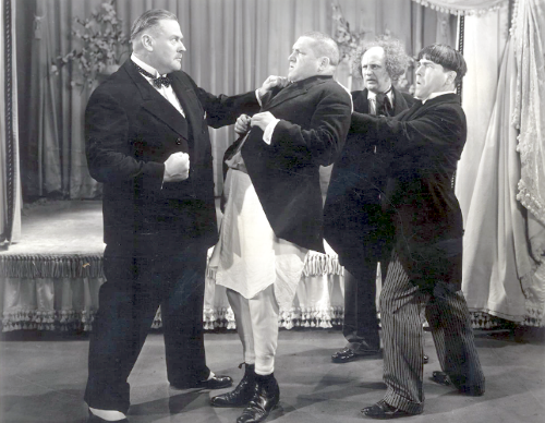 Vernon Dent confronts the Three Stooges (Curly, Larry, Moe) at the end of "Slippery Silks"